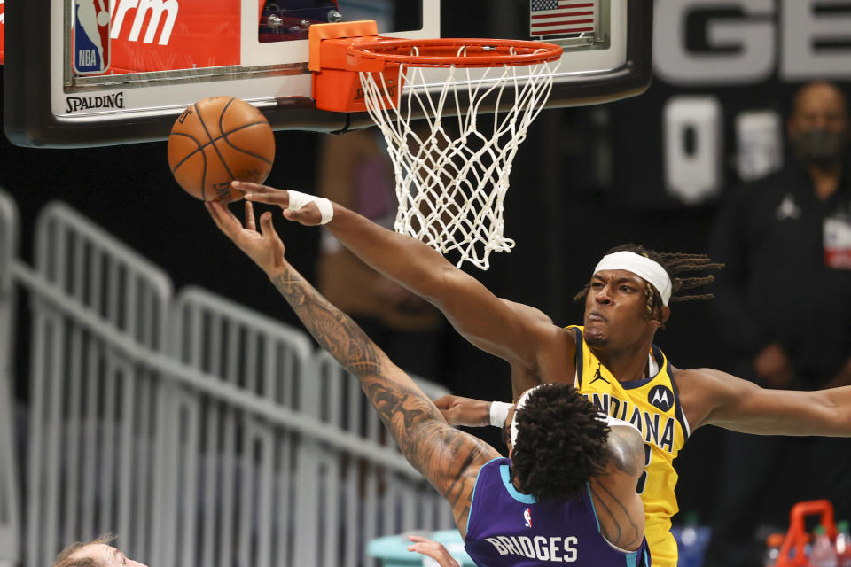 Charlotte Hornets forward Miles Bridges, left, shoots against Indiana Pacers center Myles Turner during the first half of an NBA basketball game in Charlotte, N.C., Wednesday, Jan. 27, 2021. (AP Photo/Nell Redmond)