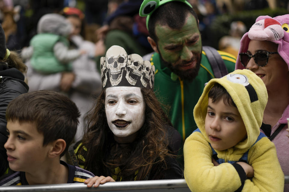 People watch the Purim parade in Jerusalem, Monday, March 25, 2024. For the first time after 42 years and amid the Israel-Hamas war, Jerusalem holds a Purim parade on Monday. (AP Photo/Leo Correa)