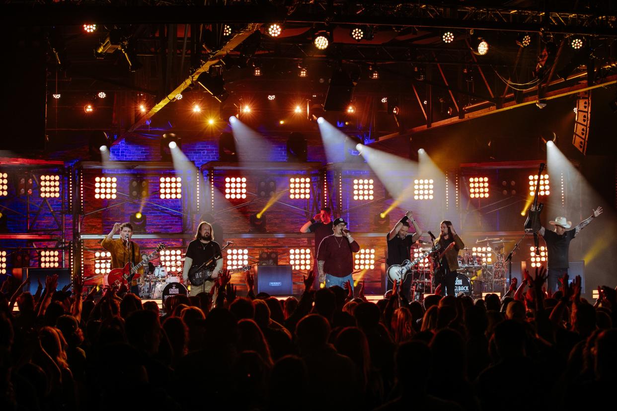 From left, Ryan Peake, Justin Loose, HARDY, Chad Kroeger, Rhett Smith and Mike Kroeger perform during "CMT Crossroads: Nickelback & HARDY" at Marathon Music Works in March.