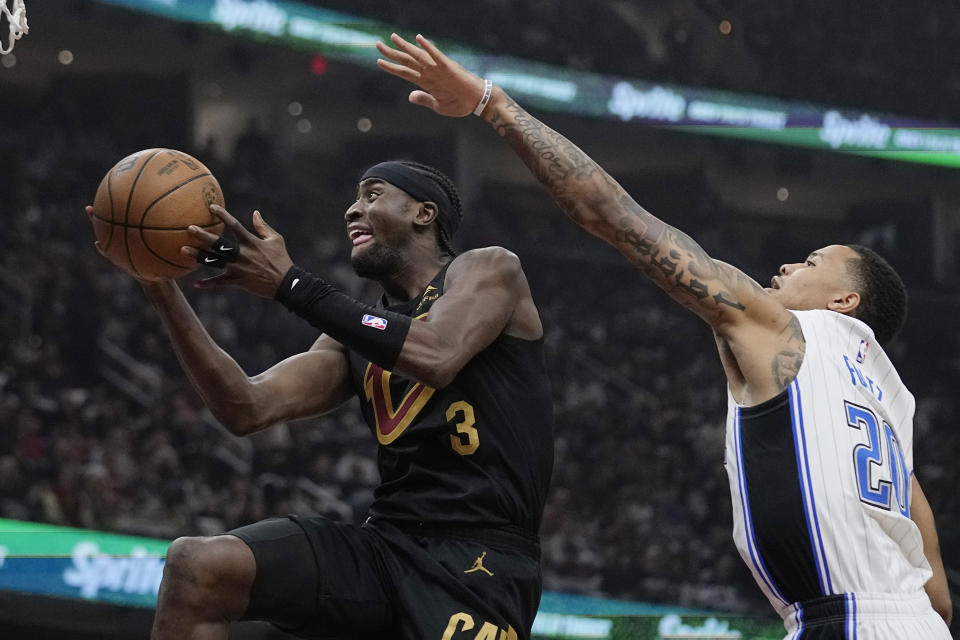 Cleveland Cavaliers guard Caris LeVert (3) goes to the basket in front of Orlando Magic guard Markelle Fultz (20) in the first half of Game 7 of an NBA basketball first-round playoff series Sunday, May 5, 2024, in Cleveland. (AP Photo/Sue Ogrocki)