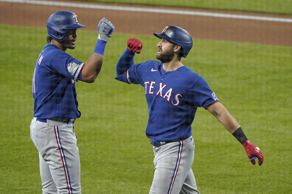 Texas Rangers' Joey Gallo, right, is greeted by Ronald Guzman, left, after hitting a solo home run against the Seattle Mariners during the second inning of a baseball game, Sunday, Sept. 6, 2020, in Seattle. (AP Photo/Ted S. Warren)