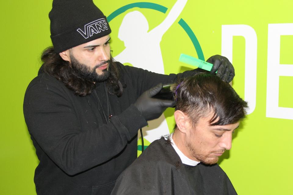 A barber cuts hair at the 2020 Super Soul Super Bowl party in Toms River.