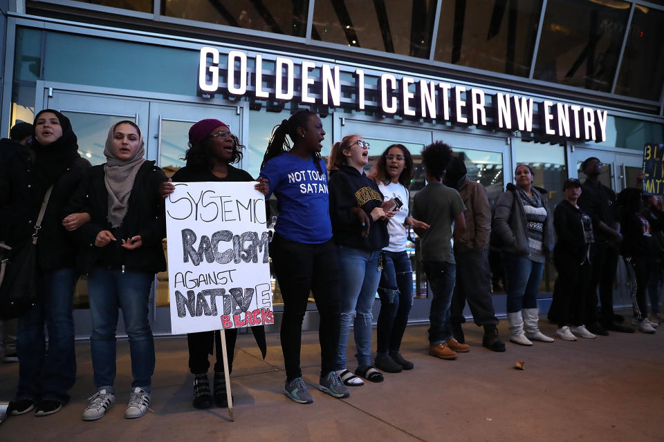 Protesters chant as they block the entrance to the Golden 1 Center.