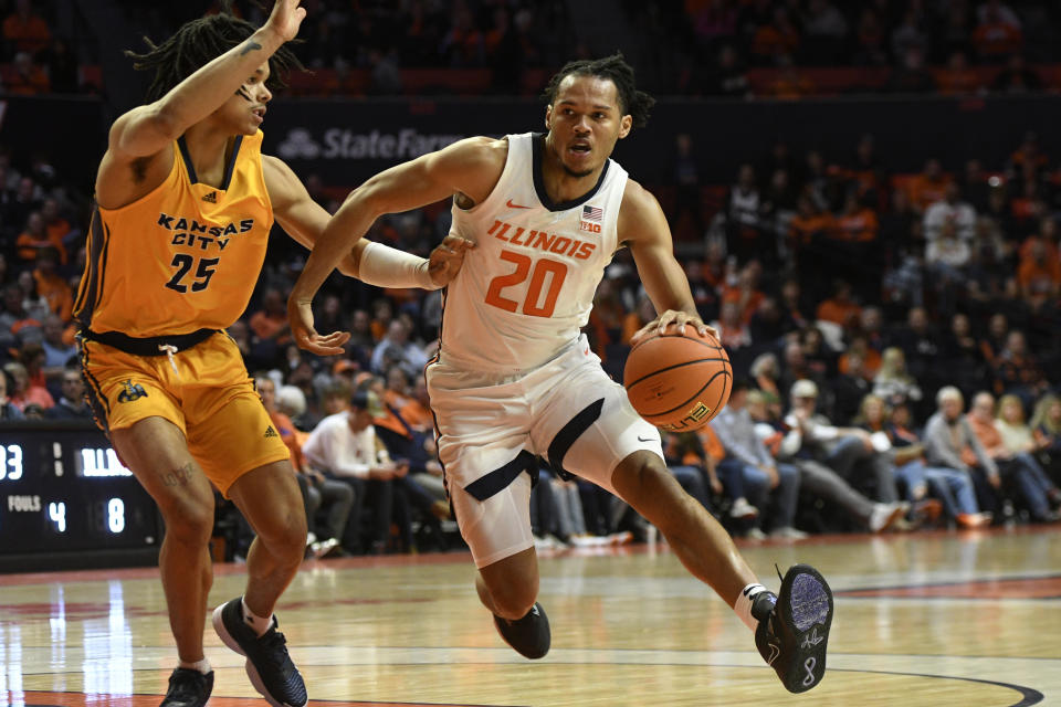 Illinois' Ty Rodgers (20) works the ball inside against Kansas City's Tyler Andrews during the first half of an NCAA college basketball game Friday, Nov. 11, 2022, in Champaign, Ill. (AP Photo/Michael Allio)