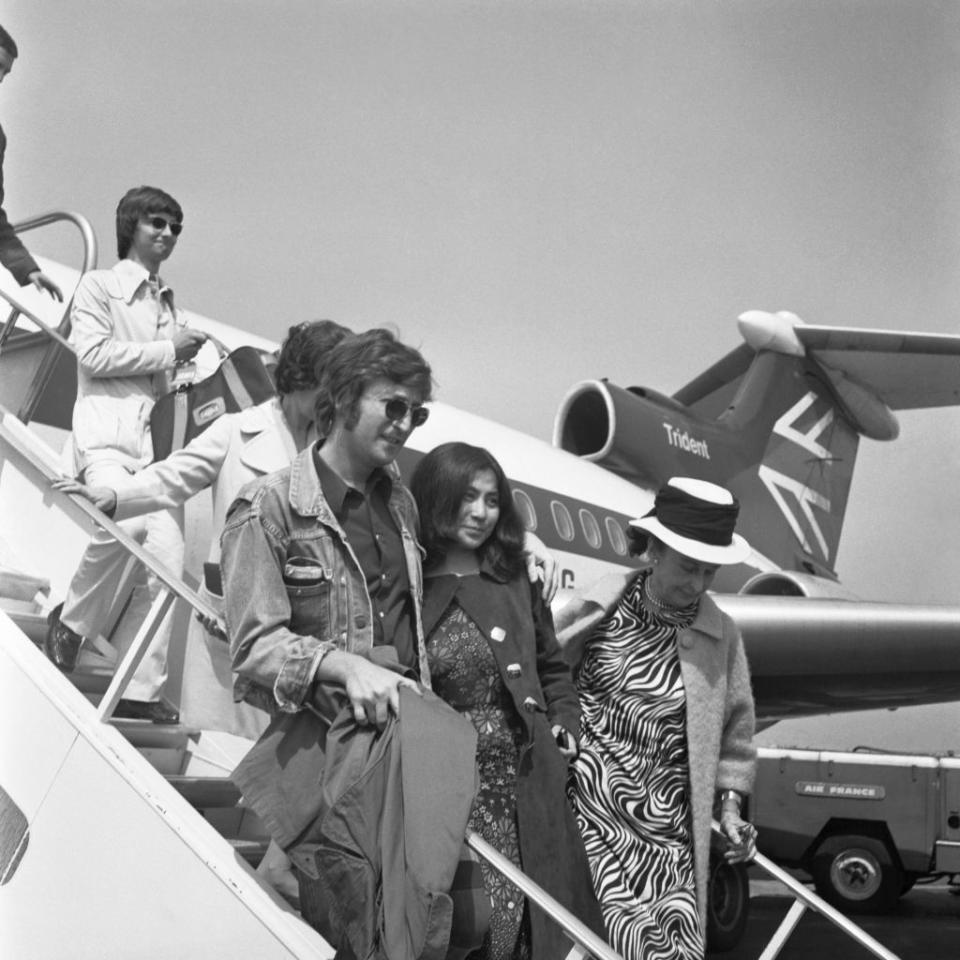 <p>John Lennon and Yoko Ono disembark from a small plane in 1971 as they arrive in France for the Cannes Film Festival, shortly after Lennon announced his departure from The Beatles. </p>