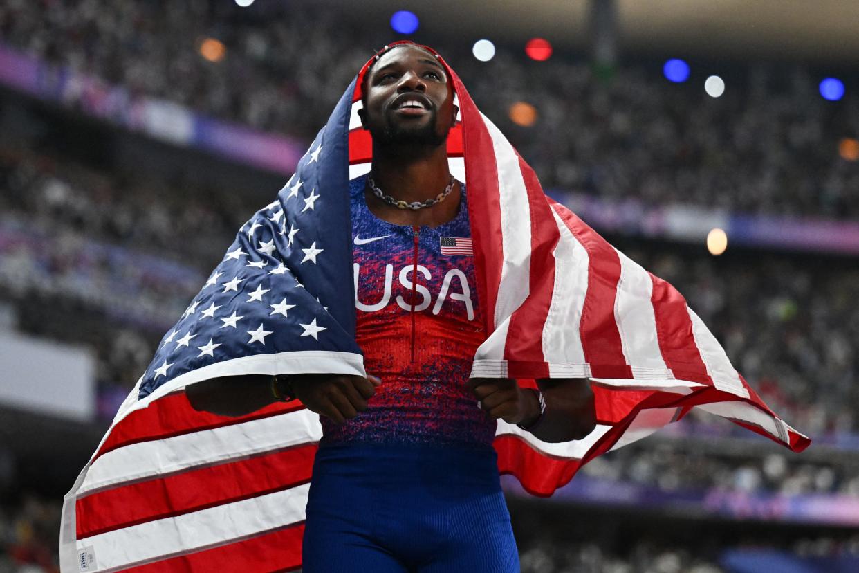 US' Noah Lyles celebrates after winning the men's 100m final of the athletics event at the Paris 2024 Olympic Games at Stade de France in Saint-Denis, north of Paris, on August 4, 2024. (Photo by Jewel SAMAD / AFP) (Photo by JEWEL SAMAD/AFP via Getty Images)