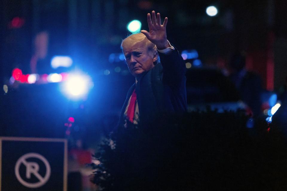 Former President Donald Trump walks into Trump Tower in New York late Tuesday.