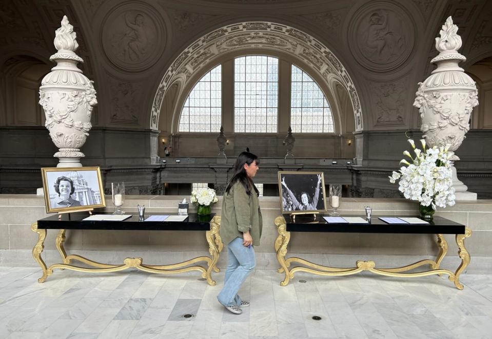 A woman walks past a table in San Francisco City Hall containing a "condolence book" for the late Sen. Dianne Feinstein