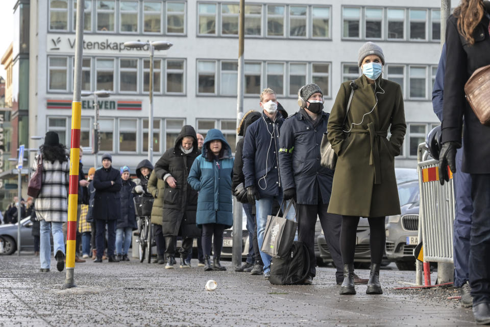 People queue for a drop-in COVID-19 vaccination at the Stockholm City Terminal station, Thursday, Jan. 13, 2022. Sweden’s prime minister, Magdalena Andersson ordered cafes, bars and restaurants to close no later than 11 p.m., urged people to work from home when possible and said distance learning was an option in higher education to try to combat rising levels of COVID-19 infection. (Anders Wiklund/TT via AP)