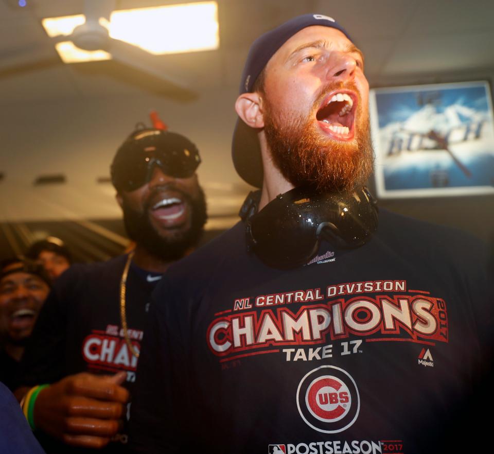 Chicago Cubs' Ben Zobrist, right, and Jason Heyward celebrate with teammates after defeating the St. Louis Cardinals to clinch the National League Central title on Sept. 27, 2017.