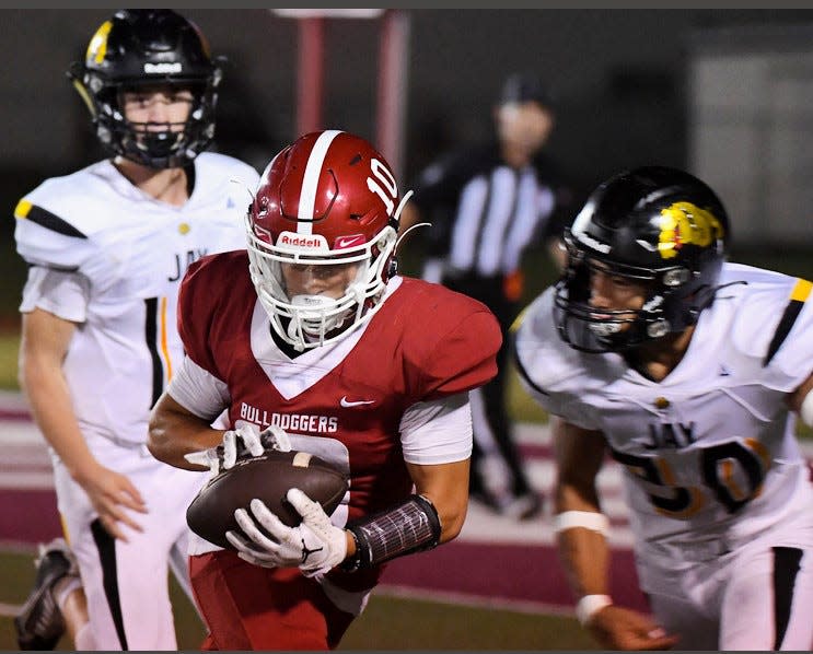 Dewey High School receiver Easton Davis, No. 10, hauls in a reception during varsity football action against Jay High School on Sept. 22, 2023 at the Dewey field.