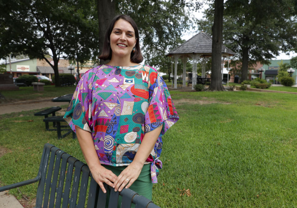 In this Aug. 5, 2019, photo, Lauren Lewis poses for a photo in the town square plaza in Mount Vernon, Texas. Art Briles, who was fired as the head coach at Baylor three years ago in the wake of a sprawling sexual assault scandal he has insisted he handled correctly, is the new high school football coach in Mount Vernon. Lewis was the only resident who publicly voiced opposition to Briles hire at a Mount Vernon school board meeting. (AP Photo/Tony Gutierrez)