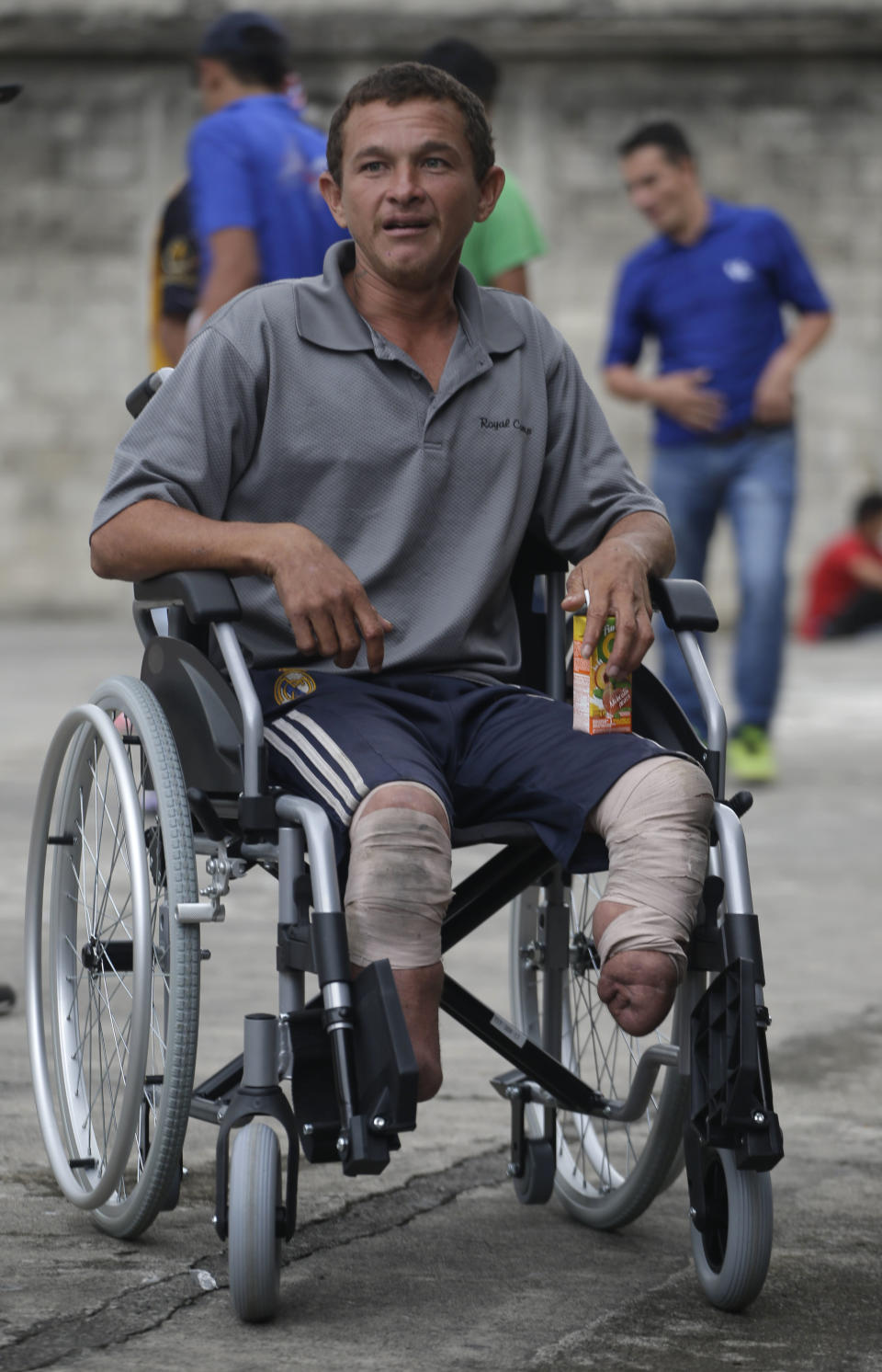 Honduras migrant Nery Maldonado Tejeda poses for photos in his new wheelchair donated to him after arriving to Guatemala City, Wednesday, Oct. 17, 2018. Maldonado said he lost his legs in 2015 while riding "The Beast," a northern-bound cargo train in Mexico, and that this is his second attempt to reach the U.S. (AP Photo/Moises Castillo)