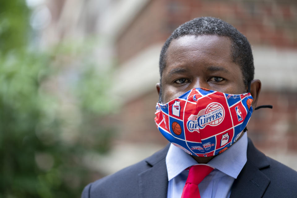 Economist Gbenga Ajilore poses for a photo outside his home in Washington, Friday, June 19, 2020. Ajilore believes the coronavirus pandemic is affecting the two largest U.S. generations, Baby Boomers and Millennials. For baby boomers, named for the post-World War II surge of births, that means those who retired or are nearing retirement age are seeing their retirement accounts appearing unreliable while their health is at high risk. Millennials, who became young adults in this century, are getting socked again as they were still recovering from the Great Recession. (AP Photo/J. Scott Applewhite)