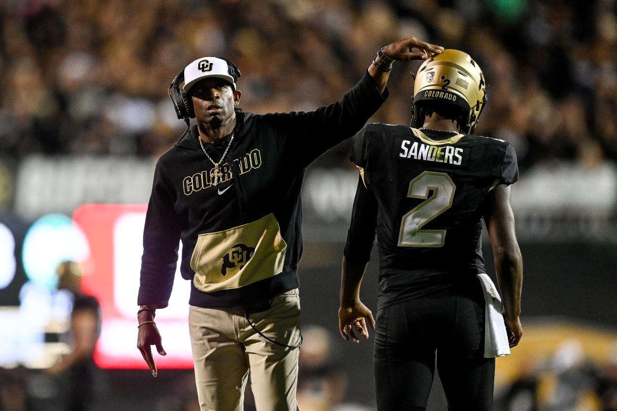 Colorado coach Deion Sanders celebrates with quarterback Shedeur Sanders during a game against Colorado State on Sept. 16. (Dustin Bradford/Getty Images)