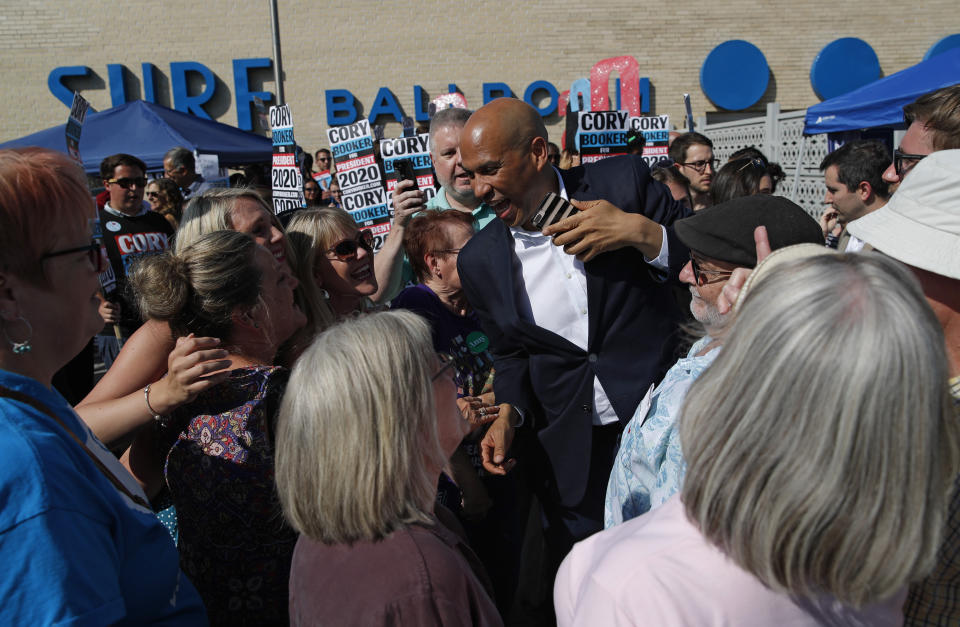 Democratic presidential candidate Sen. Cory Booker, D-N.J., center, meets with supporters before the Iowa Democratic Wing Ding at the Surf Ballroom, Friday, Aug. 9, 2019, in Clear Lake, Iowa. (AP Photo/John Locher)