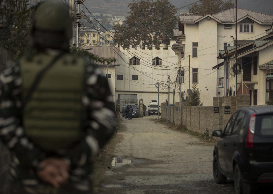 An Indian paramilitary soldier stands guard as National Investigation Agency personnel search the premises of Agence France-Presse’s Kashmir correspondent Parvaiz Bukhari on the outskirts of Srinagar, Indian controlled Kashmir, Wednesday, Oct. 28, 2020. (AP Photo/Mukhtar Khan)