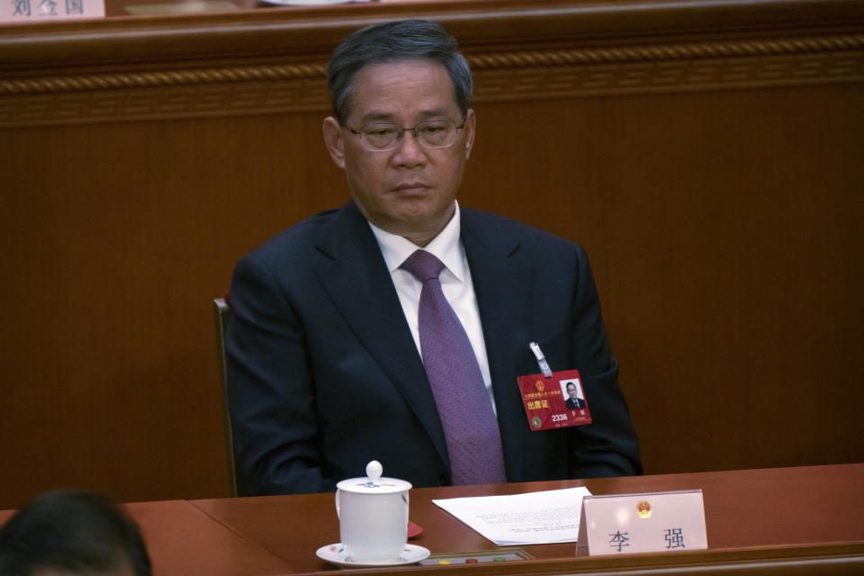 Li Qiang attends a session of China's National People's Congress (NPC) at the Great Hall of the People in Beijing, Friday, March 10, 2023. Six men sit alongside Chinese leader Xi Jinping on the ruling Communist Party's all-powerful Politburo Standing Committee, handling major portfolios from propaganda to corruption fighting. (AP Photo/Mark Schiefelbein)