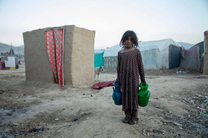 A girl collects water in IDP camp in northeast Afghanistan (Arete/DEC)