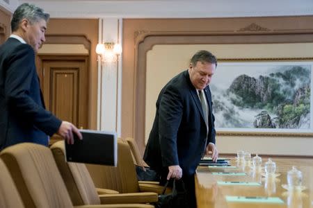 Secretary of State Mike Pompeo, center, accompanied by U.S. Ambassador to the Philippines Sung Kim, left, arrives for a meeting with Kim Yong Chol, a North Korean senior ruling party official and former intelligence chief, for a second day of talks at the Park Hwa Guest House in Pyongyang, North Korea, Saturday, July 7, 2018. Andrew Harnik/Pool via Reuters