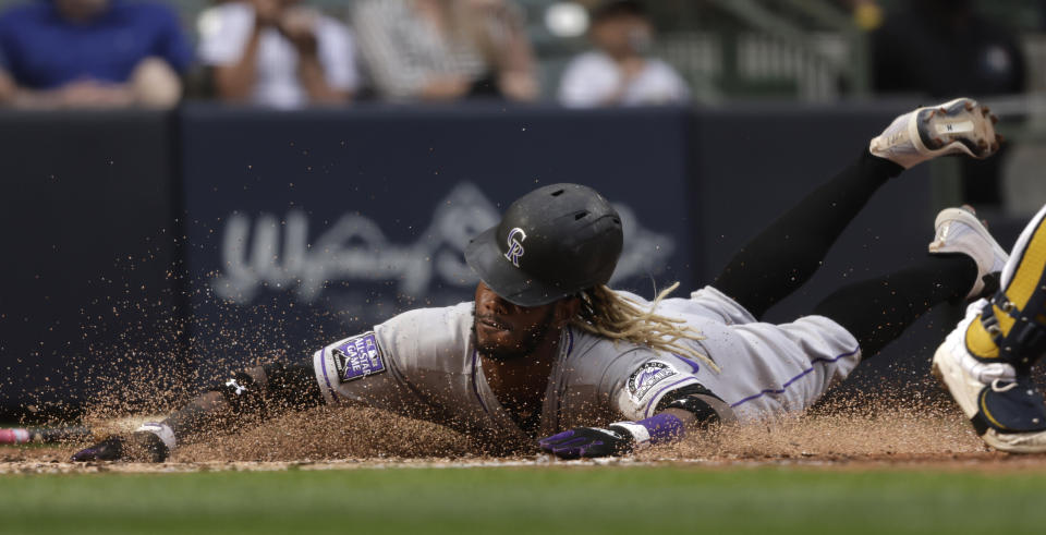 Colorado Rockies left fielder Raimel Tapia scores on a double by Rockies' Yonathan Daza during the fifth inning of a baseball game against the Milwaukee Brewers, Friday, June 25, 2021, in Milwaukee. (AP Photo/Jeffrey Phelps)