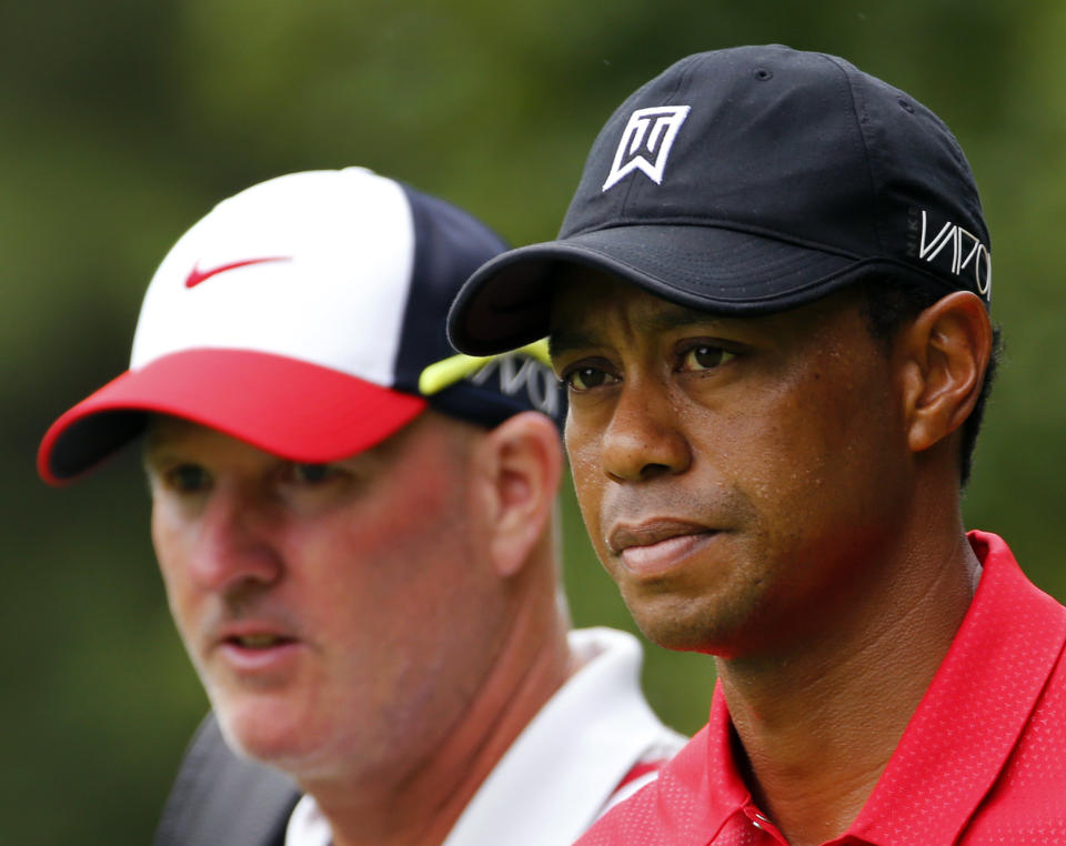 A selfie-seeking fan is the source of legal headaches for Tiger Woods and his caddie. (AP Photo/Steve Helber)