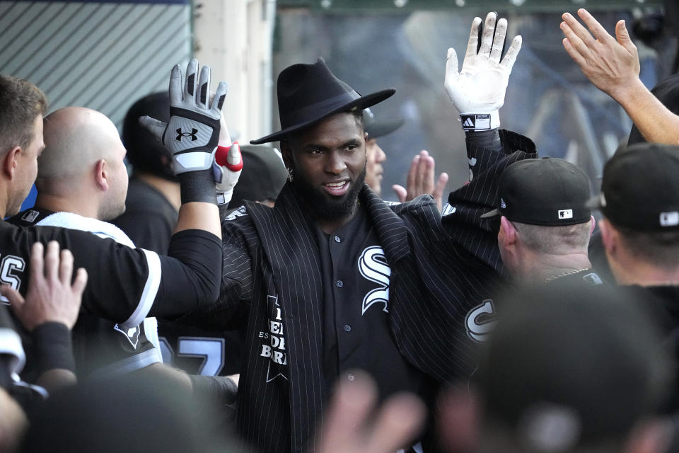 Chicago White Sox's Luis Robert Jr. is congratulated by teammates in the dugout after hitting a two-run home run during the first inning of a baseball game against the Los Angeles Angels Wednesday, June 28, 2023, in Anaheim, Calif. (AP Photo/Mark J. Terrill)