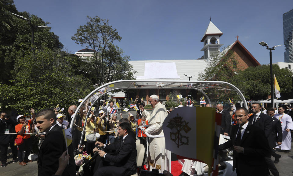 Pope Francis greets the crowd at Saint Louis Hospital in Bangkok, Thailand, Thursday, Nov. 21, 2019. Pope Francis called for migrants to be welcomed and for women and children to be protected from exploitation, abuse and enslavement as he began a busy two days of activities in Thailand on Thursday. (AP Photo/Manish Swarup)