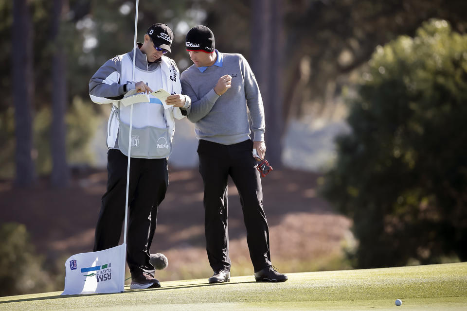 Charles Howell III, right, plans his shot with his caddie Nick Jones, left, on the sixth green during the second round of the RSM Classic golf tournament on Friday, Nov. 16, 2018, in St. Simons Island, Ga. (AP Photo/Stephen B. Morton)