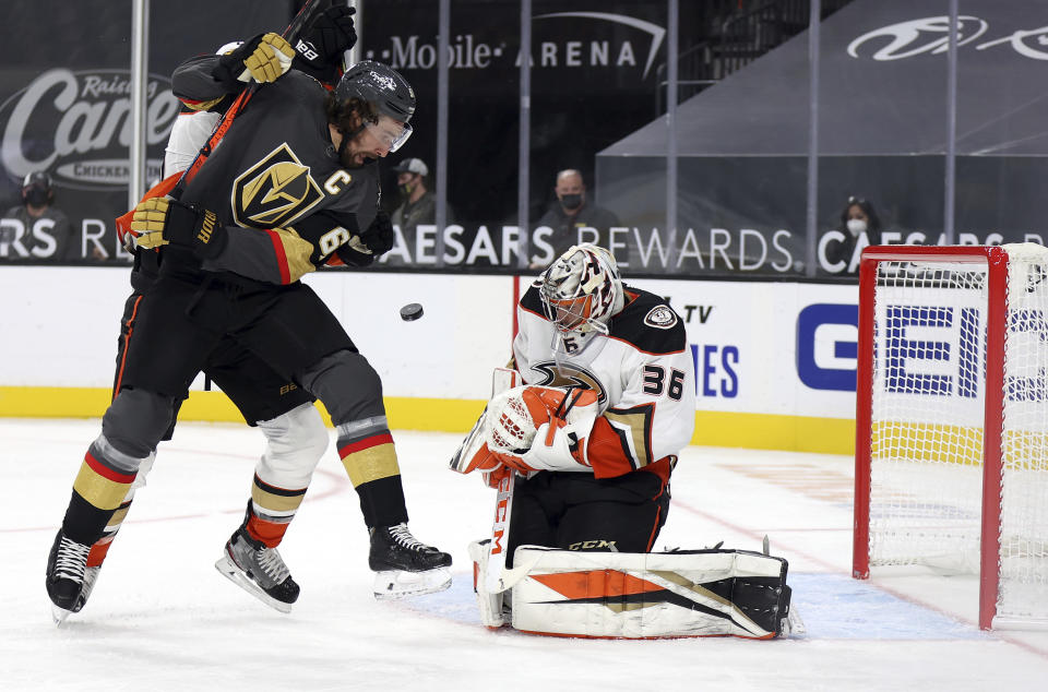 Anaheim Ducks goalie John Gibson (36) blocks a shot as Vegas Golden Knights right wing Mark Stone (61) looks for the rebound during the second period of an NHL hockey game Thursday, Jan. 14, 2021, in Las Vegas. (AP Photo/Isaac Brekken)