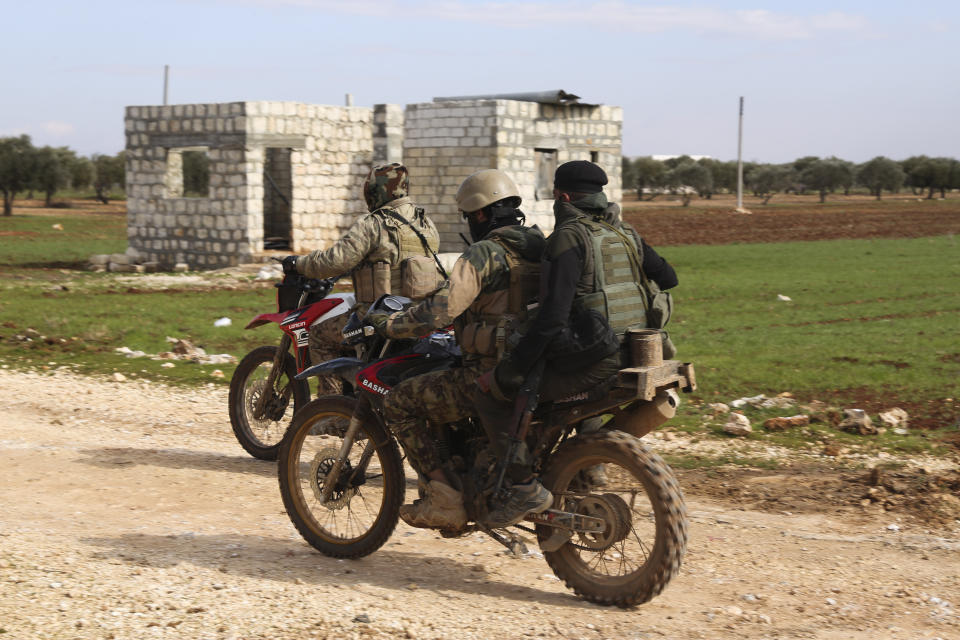 Turkish backed fighter prepare to go to the frontline in the Syrian province of Idlib, Monday, Feb. 10, 2020. The fighting in Idlib led to the collapse of a fragile cease-fire that was brokered by Turkey and Russia in 2018. Turkey supports the Syrian rebels, while Russia has heavily backed the Syrian government's campaign to retake the area which is the last rebel stronghold in Syria. (AP Photo/Ghaith Alsayed)