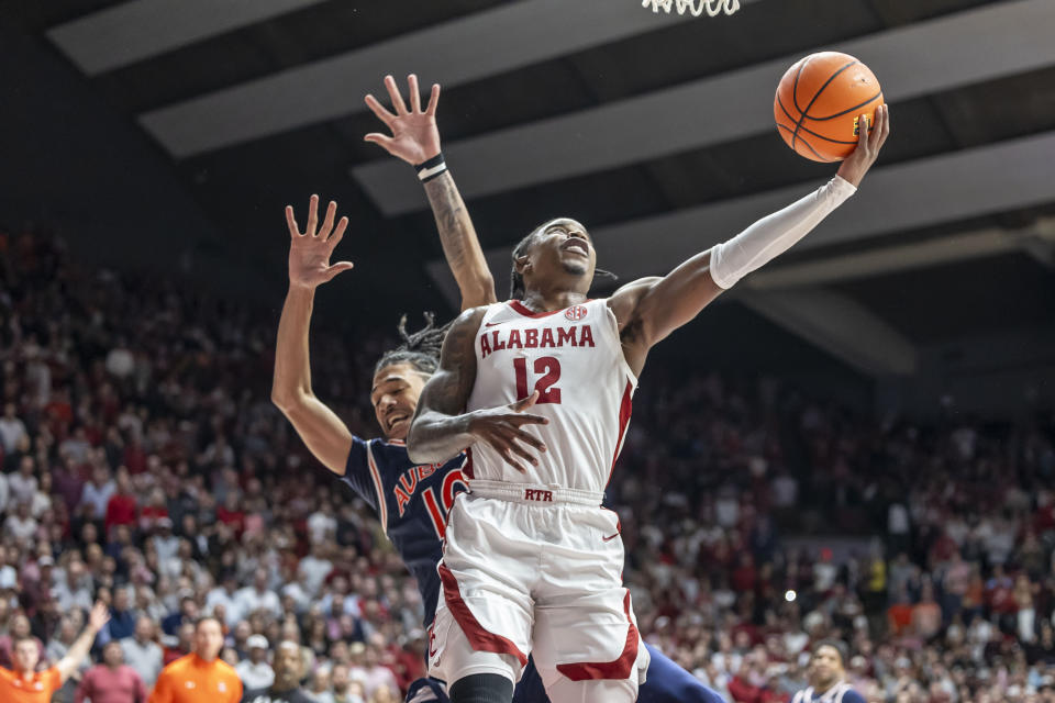 Alabama guard Latrell Wrightsell Jr. (12) gets by Auburn guard/forward Chad Baker-Mazara (10) for a shot during the first half of an NCAA college basketball game Wednesday, Jan. 24, 2024, in Tuscaloosa, Ala. (AP Photo/Vasha Hunt)