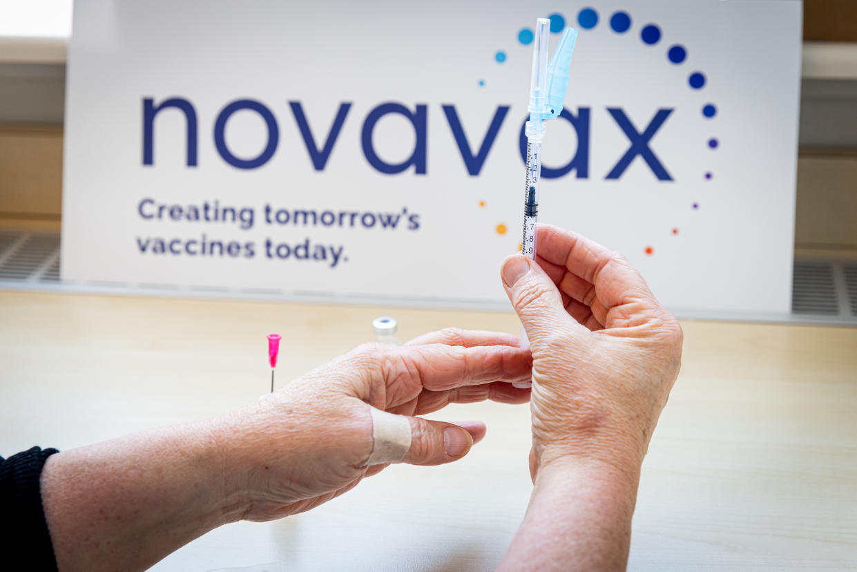 A health worker in the Netherlands prepares a dose of the Novavax vaccine