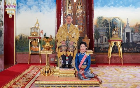 Thailand's King Maha Vajiralongkorn posing with royal noble consort Sineenat Bilaskalayani - Credit: AFP