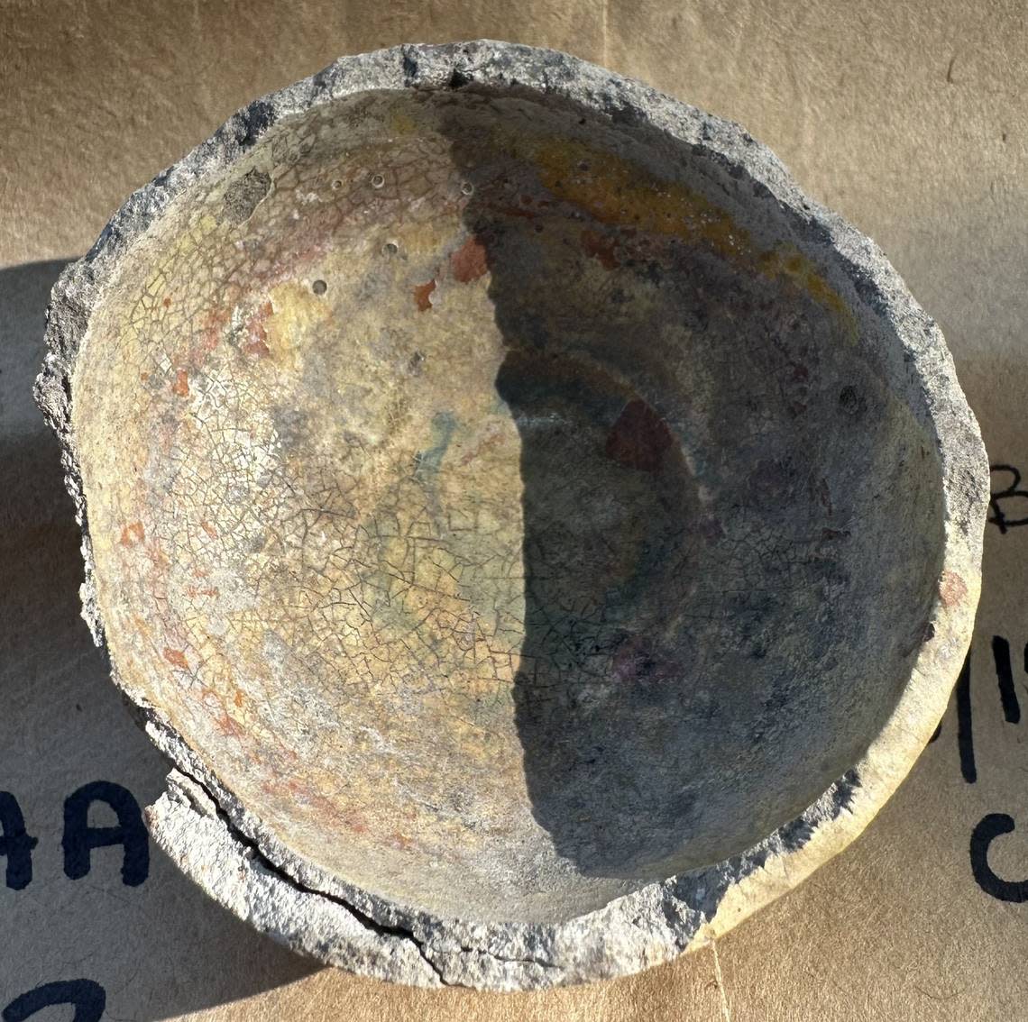 The cupel, used in the process of purifying gold and silver, is still stained with the minerals, such as lead, copper, zinc or arsenic, that were leached out of ore in the purification process.