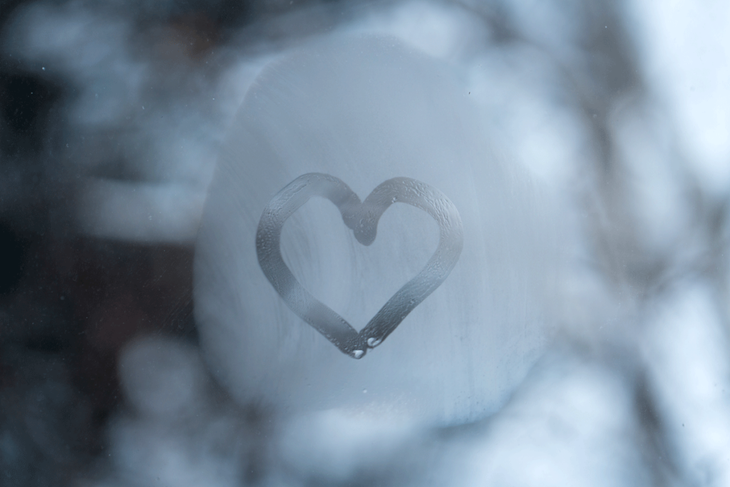 Fog on a window with a heart drawn in it