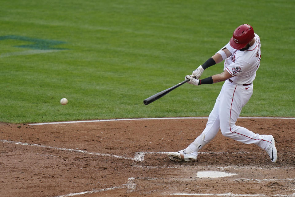 Cincinnati Reds' Jesse Winker hits a single during the second inning of a baseball game against the Pittsburgh Pirates at Great American Ballpark in Cincinnati, Thursday, Aug. 13, 2020. (AP Photo/Bryan Woolston)