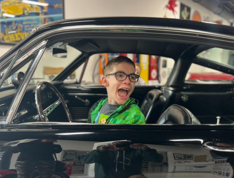 Alexander Hopper, 13, from Denver, Colorado got behind the wheel of a vintage Shelby Mustang at the Maine Classic Car Museum, where his family stopped after their Retinalblastoma Family week at Camp Sunshine.