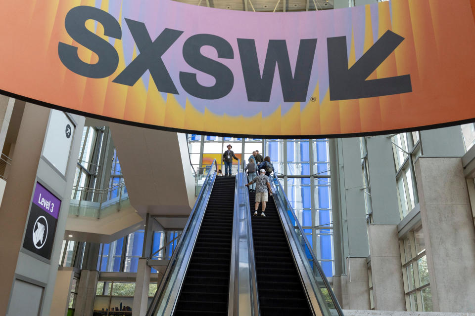 Attendees use the escalator during the Austin Convention at the South by Southwest Conference in Austin, Texas, U.S. March 16, 2023. REUTERS/Nuri Vallbona