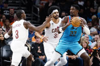 Cleveland Cavaliers' Caris LeVert (3) and Jarrett Allen (31) put pressure on Phoenix Suns' Deandre Ayton (22) during the first half of an NBA basketball game in Phoenix, Sunday, Jan. 8, 2023. (AP Photo/Darryl Webb)