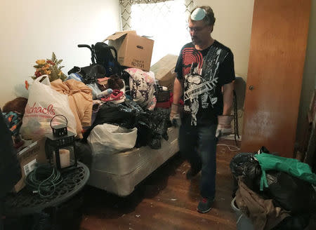 Jose Luis Perales walks through his home with articles of clothes and damaged household goods piled up inside his home left from the flooding caused by Hurricane Harvey, in Houston, Texas, U.S., September 1, 2017. REUTERS/Mica Rosenberg