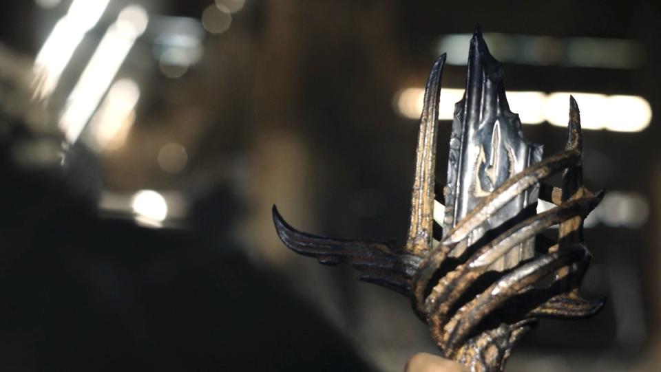 Theo looks at the hilt of Sauron's sword on The Rings of Power