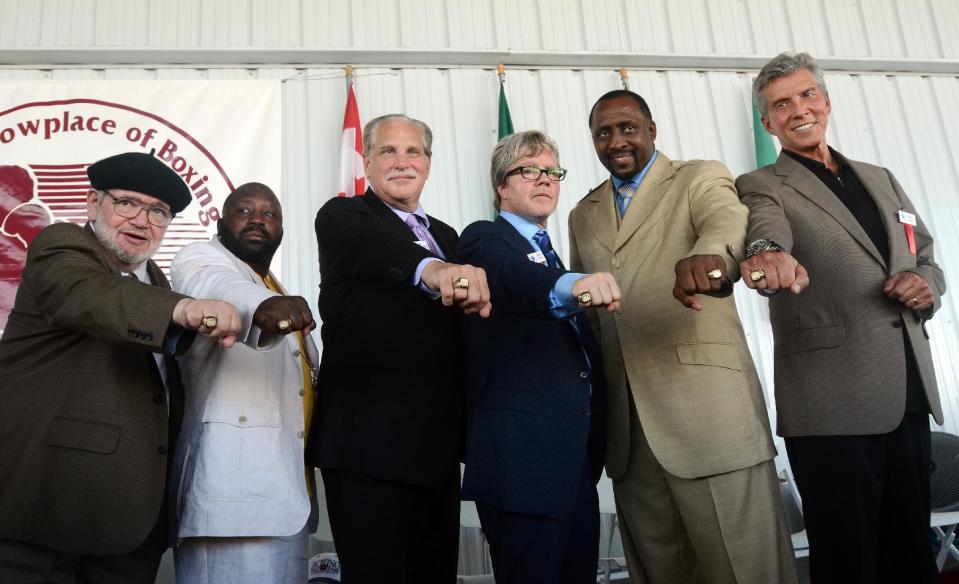 International Boxing Hall of Fame inductees, from left, Michael Katz, Mark Johnson, Al Bernstein, Freddie Roach, Thomas Hearns and Michael Buffer pose with their Hall of Fame rings at the induction ceremony in Canastota, N.Y., Sunday, June 10, 2012. (AP Photo/Heather Ainsworth)