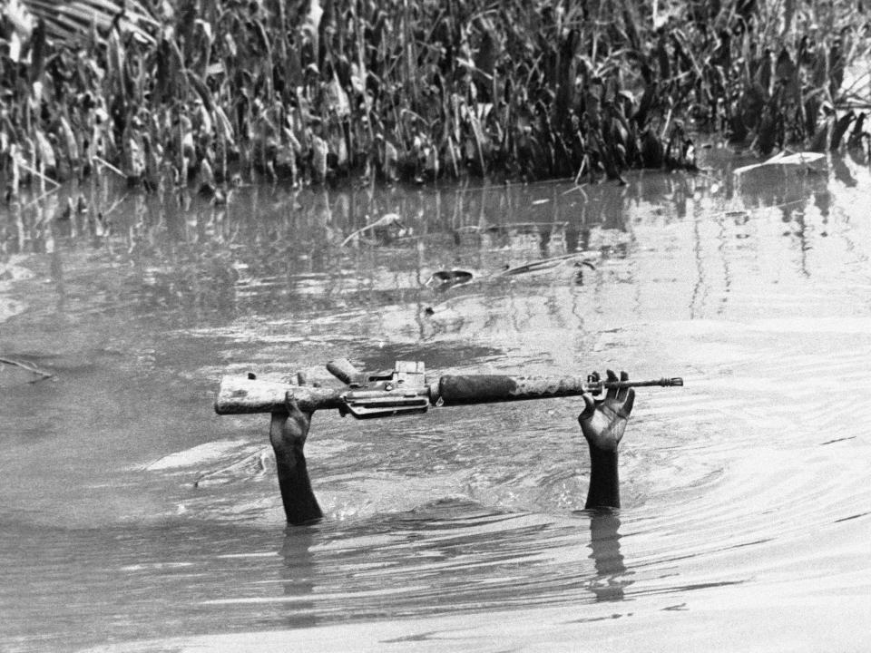 A soldier keeps his M16 out of the water while crossing a Mekong Delta waterway in Vietnam in May 1969.