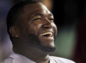 FILE - Boston Red Sox designated hitter David Ortiz laughs with teammates in the dugout after hitting a double for his 2,000th career hit, in the sixth inning of a baseball game against the Detroit Tigers at Fenway Park in Boston, on Sept. 4, 2013. Ortiz was elected to the National Baseball Hall of Fame on Tuesday, Jan. 25, 2022. (AP Photo/Elise Amendola, File)