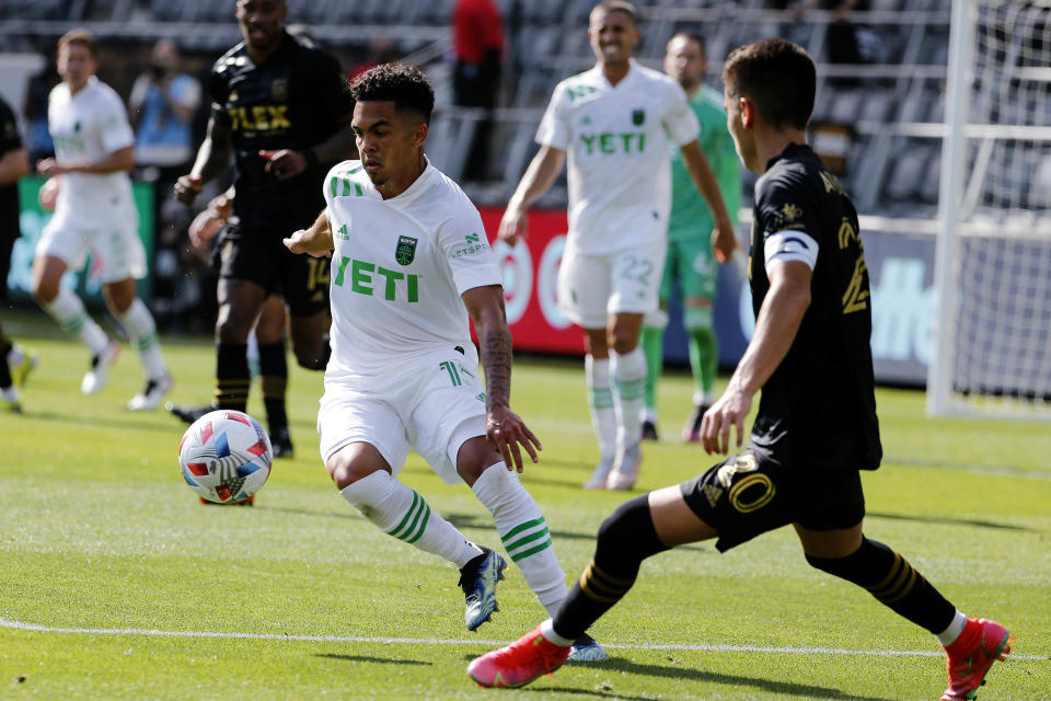 Austin FC midfielder Daniel Pereira Gil (15) controls the ball away from Los Angeles FC midfielder Eduard Atuesta (20) during the second half of an MLS soccer match Saturday, April 17, 2021, in Los Angeles. (AP Photo/Ringo H.W. Chiu)