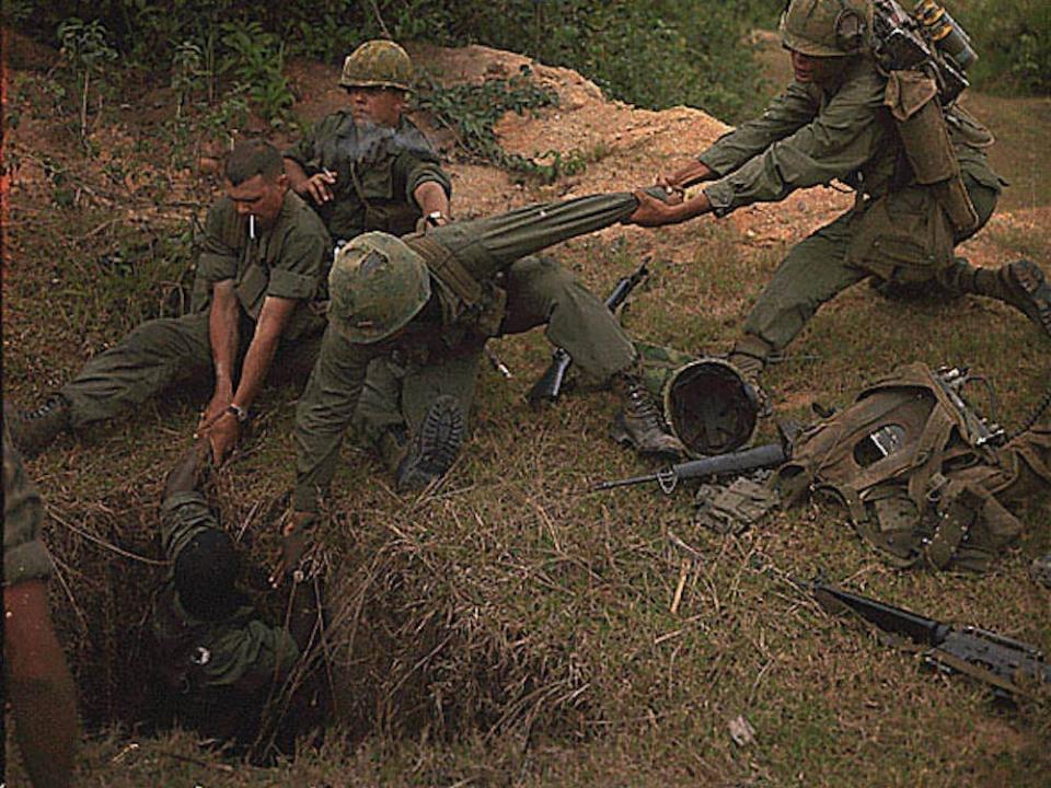 U.S. soldiers lower a member of their reconnaissance platoon into a Viet Cong tunnel during a search and destroy mission in Vietnam, April 24, 1967.