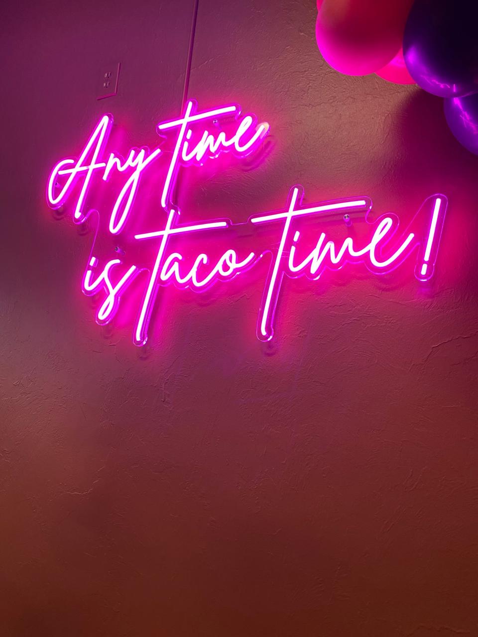 This pink neon sign is one of the decorating touches at the new Taco Empire brick and mortar location.