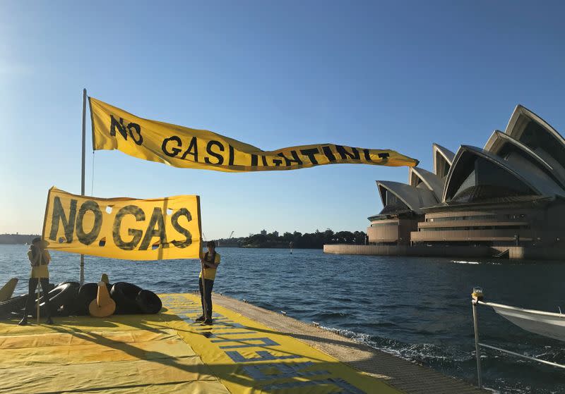 Ambrose Hayes, a 15-year-old climate change activist, rides on a barge during an event as part of the Fund Our Future Not Gas climate rally in Sydney Harbour