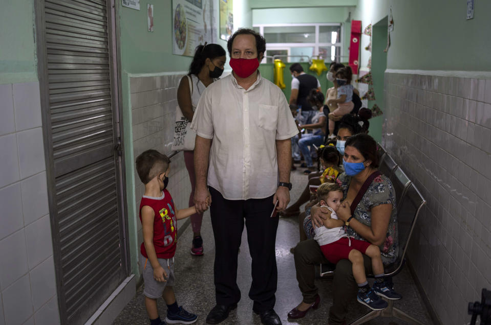 Parents wait to have their children vaccinated with the Soberana-02 COVID-19 vaccine, in Havana, Cuba, Thursday, Sept. 16, 2021. Cuba began inoculating children as young as 2-years-old with locally developed vaccines on Thursday. (AP Photo/Ramon Espinosa)